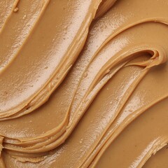 Creamy nut butter spread close-up with beautiful swirled texture, perfect for food backgrounds
