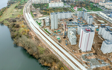 aerial view of city construction site. modern concrete buildings under construction. development of residential area.