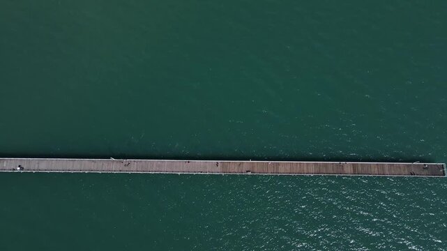Urangan Pier Hervey Bay a historic 1 kilometer timber structure now a top tourist attraction for fishing, scenic walking, and spotting marine life.