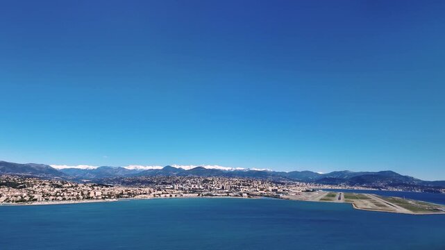 Immersive Pilot POV in the final approach to NIce Airport (NCE), with a view of the city and snow-covered Alps mountains in the background