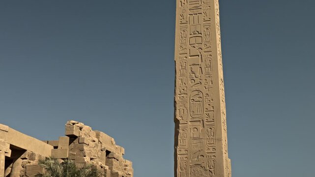 This image features the Obelisk of Hatshepsut, one of the tallest standing ancient obelisks in Egypt, located in the heart of the Karnak Temple Complex.