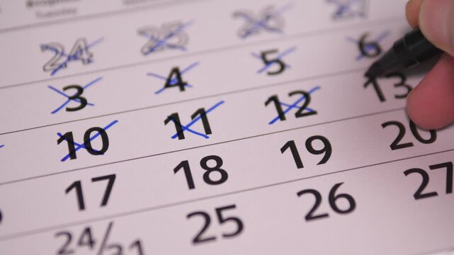 Calendar Detailed Calendar Adjustments. Precise Hand Editing On Calendar To Reschedule And Correct Dates. Closeup Image Of Hand Meticulously Editing Calendar With Blue Pen For Scheduling