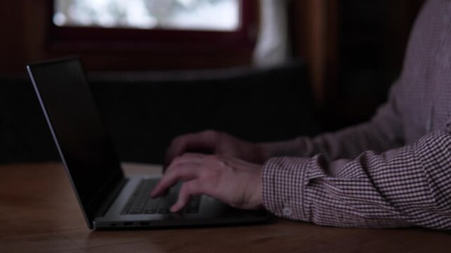 Man Working Diligently. Individual Carefully Typing Figures Into Spreadsheet. Male Professional Methodically Recording Numerical Information Into Digital Spreadsheet In Welllit Environment