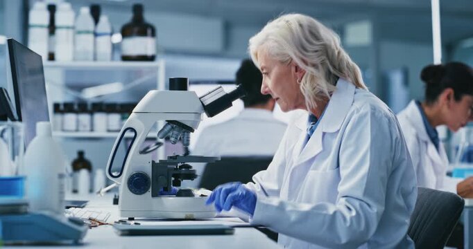 Cell, analysis and woman with microscope, lab and medical study for mRNA vaccine and pharmaceutical. Clinic, scientist and research for HIV cure development, innovation and mature person with tech