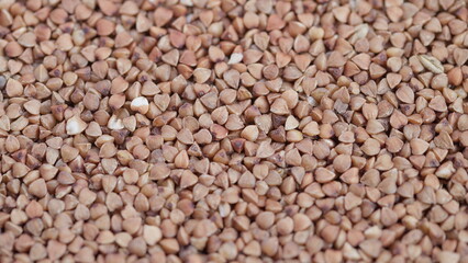 Buckwheat kernels closeup, Close view of organic buckwheat kernels with fine grain, Macro photograph showcasing raw buckwheat with detailed textures and warm beige hues