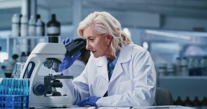 Writing, research and woman with microscope, lab and medical study for mRNA vaccine or cell analysis. Clinic, scientist and notes for HIV cure development, innovation and mature person with tech