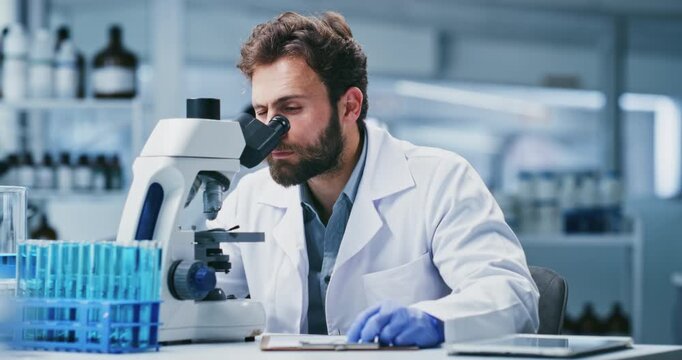 Writing, research and man with microscope, lab and medical study for mRNA vaccine and pharmaceutical. Serious, scientist and notes for HIV cure development, innovation and person with equipment