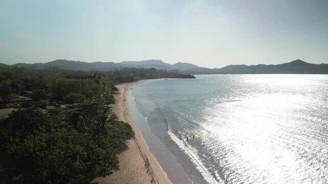 Aerial above Playa Brasilito Costa Rica white sand beach on Pacific Ocean