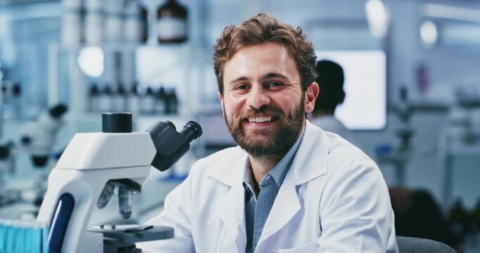 Face, man and scientist with microscope in lab for research, sample analysis and experiment. Portrait, male person and happiness for biotechnology, medical study and equipment for vaccine development