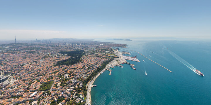 Istanbul, Turkey. Uskudar district, port and container ship in Bosphorus strait near Marmara Sea. Aerial view of Asian shore maritime activity at summer midday. Aerial view