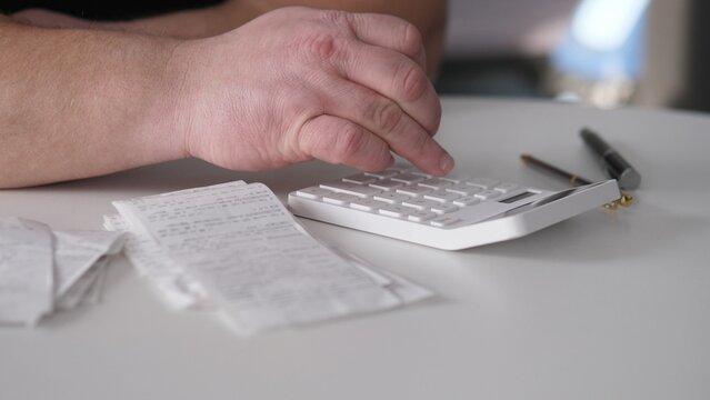 Analyzing Receipts With Calculator Tools. Specialist Meticulously Doublechecks Totals On Calculator To Ensure Financial Statement Accuracy And Reliability