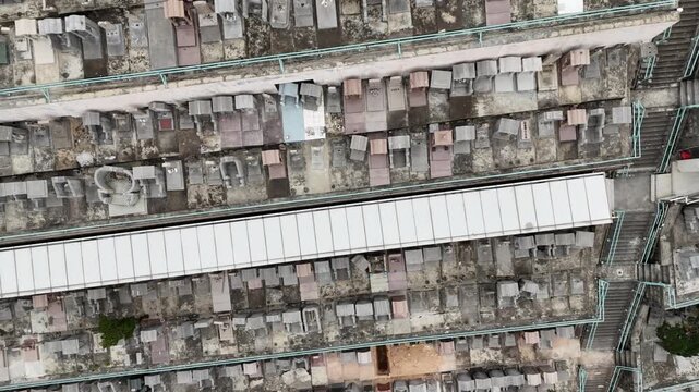 Drone aerial capturing Pok Fu Lam Cemetery in Hong Kong, with hillside tombs, lush greenery, and panoramic cityscape in a tranquil and scenic setting.