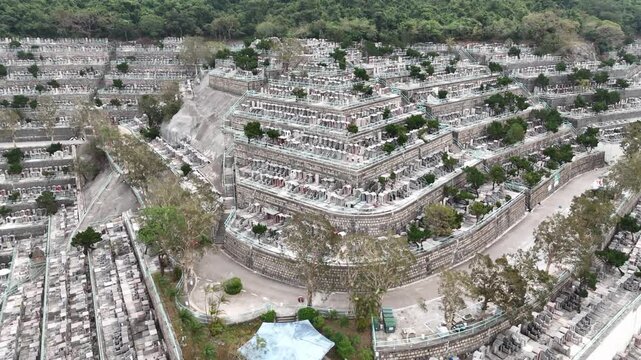 Drone aerial view of Pok Fu Lam Cemetery in Hong Kong, capturing hillside tombs, greenery, and panoramic urban cemetery layout from above.