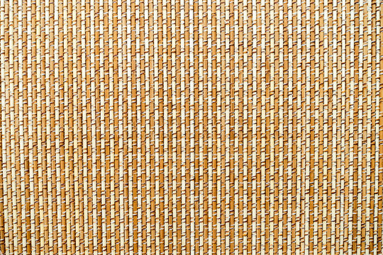 The surface of the mat is woven from light brown fine bamboo.