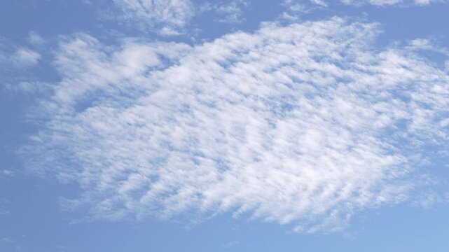 Soft clouds on blue sky forming natural cloud texture, gentle cloud pattern slowly drifting creating calm atmospheric sky background