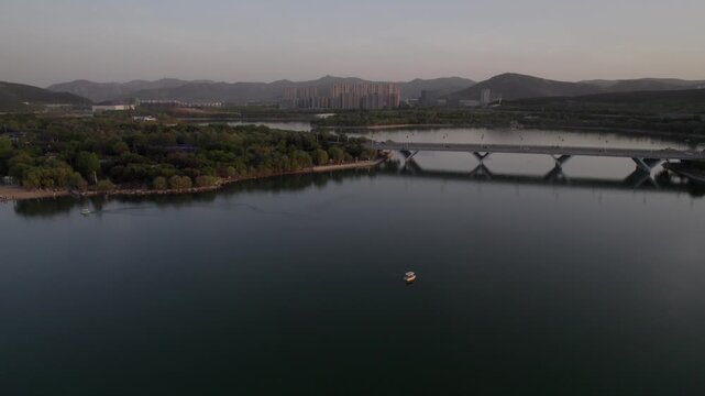Aerial View of a Bridge Over a River Surrounded by Dense High-Rise Buildings in China
