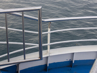 Safety Railing and Metal Guard on Ship Deck Above the Deep Blue Sea