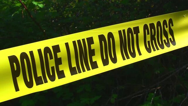 A 4K stock video of a police line cordon tape. Filmed at 4K.