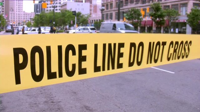 Police Line Do Not Cross police sirens in the background. caution tape with a police car.