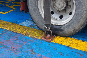 Cargo Securing Ratchet Strap Fixing a Heavy Truck to a Ferry Ship Deck