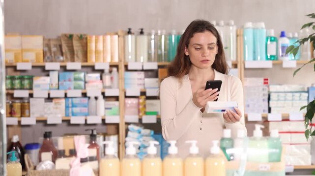 Woman in summer clothes scans code on package of ointment to check the expiration date. High quality 4k footage