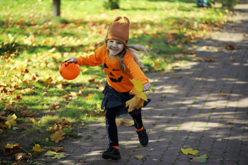 Fototapeta premium Happy family walk in the park on Halloween. Family dressed up in Halloween costumes