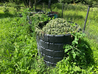 Zero Waste Composting in Black Plastic Bins with Garden Debris. Compost barrel. Rot pot or Trash-to-compost bin. Garden recycler. © AB-7272
