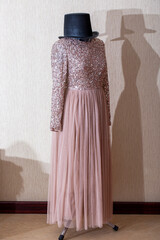 A beautiful women's dress on a mannequin with a hat