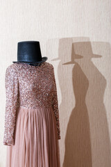 A beautiful women's dress on a mannequin with a hat