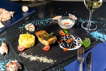 Gourmet Fish Dish with Rice and Caviar on Slate Plate
