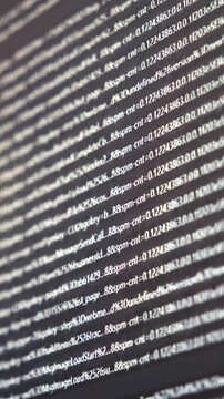 Blurred computer screen displaying terminal output with lines of code and system logs on a dark interface.
