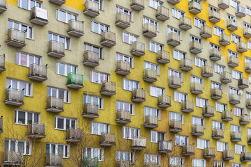 Old obsolete block building with yellow balconies. Soviet architecture in Europe	
