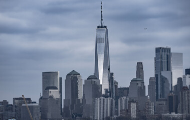 Obraz premium Manhattan cityscape over waterfront. NYC skyline scenic river view. New York City skyline iconic panorama. Manhattan skyline photography scene. NYC skyline modern American city.