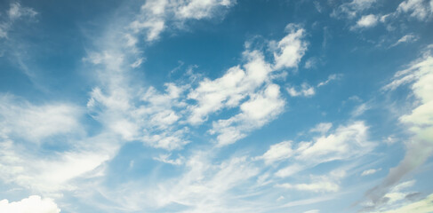 the sky is full of white clouds, bright blue, and beautiful sunlight.