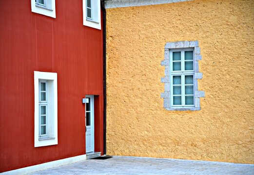 Old Neoclassical public buildings with Venetian stucco walls and windows with a white trim in Leonidio a rural town of Arcadia in Peloponnese, Greece.