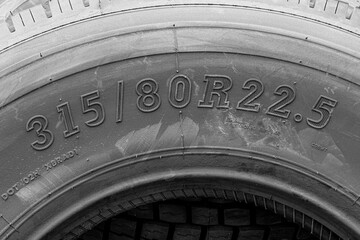 Close-Up of Truck Tire Sidewall Showing Size Markings: 315-80R22.5 on Heavy-Duty Treaded Tire