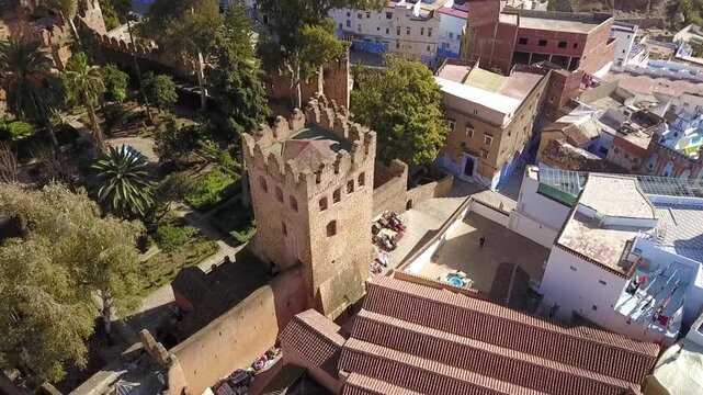 Stunning HD aerial view of the historical Kasbah tower and gardens in Chefchaouen. Showcases the ancient stone fortress and traditional architecture of Morocco&rsquo;s Blue City. Ideal for travel and histor