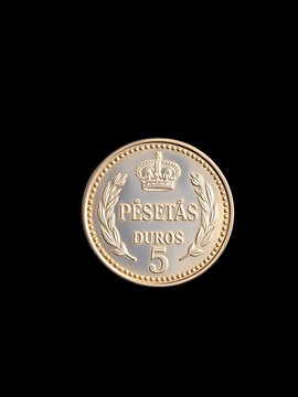 Silver 5 pesetas coins, duros, on a black background