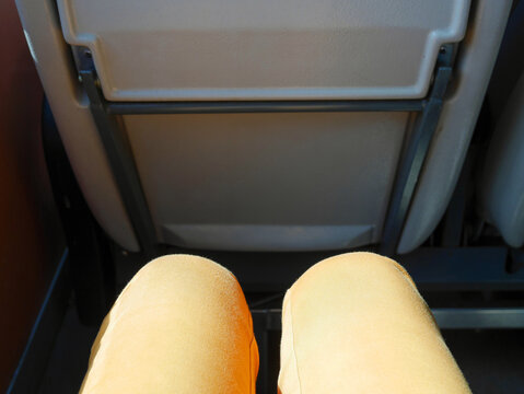 Woman's leg, she sitting in the window seat