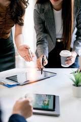 Close-up of business professionals analyzing ESG sustainability reports and financial data on a...
