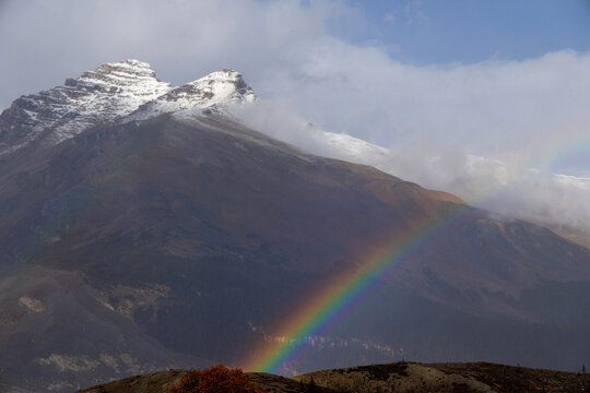 Rainbow along mountains of Icefields Parkway.