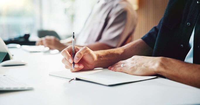 Person, hands and writing with book for business planning, schedule or reminder on office desk. Writer, journalist and taking notes with notebook or diary for project ideas, company agenda or tasks