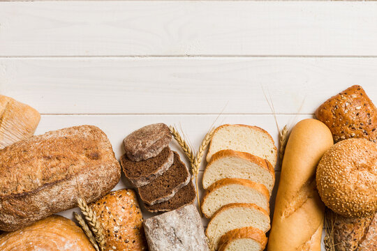 Homemade natural breads. Different kinds of fresh bread as background, top view with copy space