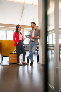 Business colleagues talking in modern office during casual meeting