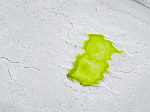 Aerial view of a vibrant green splash against a textured, chalk-white surface, Old Chandler Potash Mine Site, Western Australia, Australia.