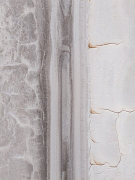 Aerial view of cracked earth textures, a stark contrast of white and grey, create a mesmerizing, abstract tableau, Old Chandler Potash Mine Site, Western Australia, Australia.