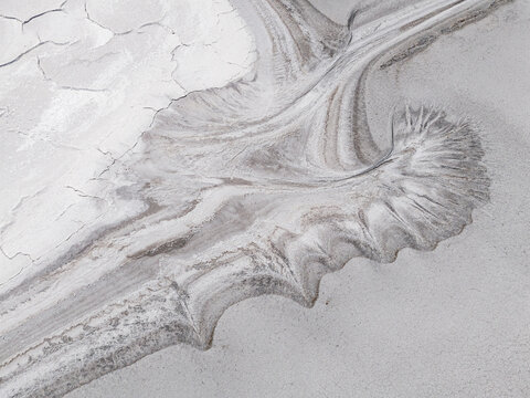 Aerial view of swirling patterns and cracked earth create a desolate yet captivating landscape at the Old Chandler Potash Mine Site, Old Chandler, Western Australia, Australia.