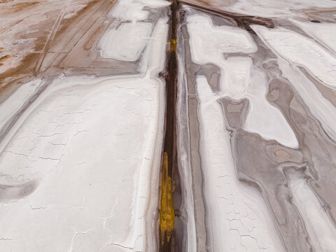 Aerial view of the stark, cracked earth meeting the pale horizons in a mesmerizing dance of colors, Old Chandler Potash Mine Site, Western Australia, Australia.
