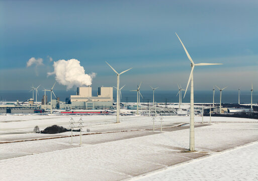 Wind turbines and power station in snow at Eemshaven the Netherlands