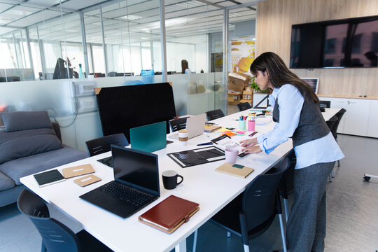 Employee organizing desk in a modern office workspace
